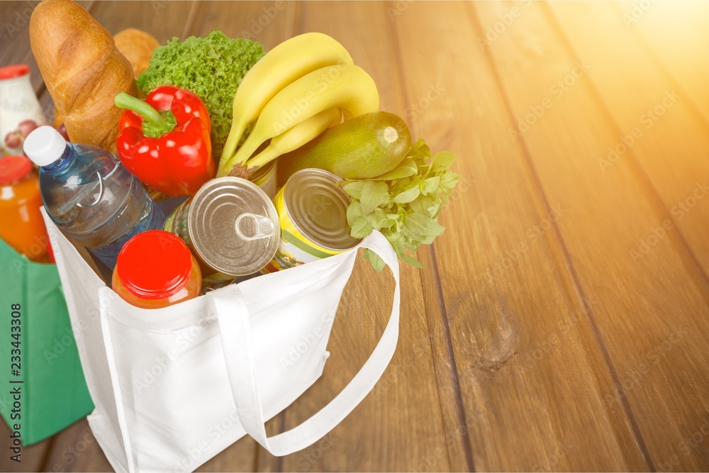 Full white shopping bag on bronw wooden background