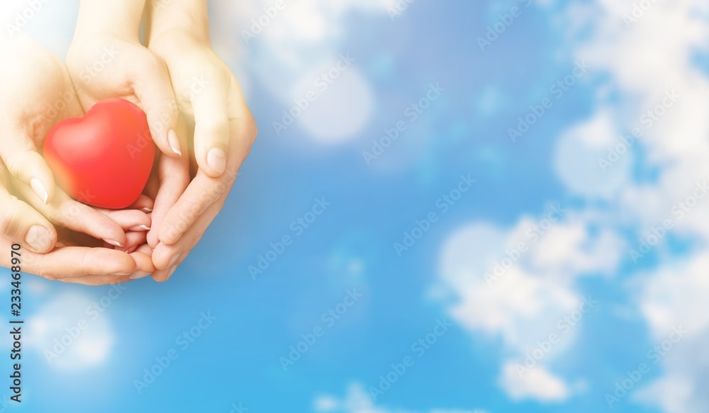 Man and woman holding red heart in hands isolated