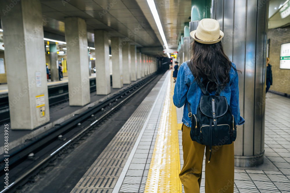 female backpacker walking in subway station