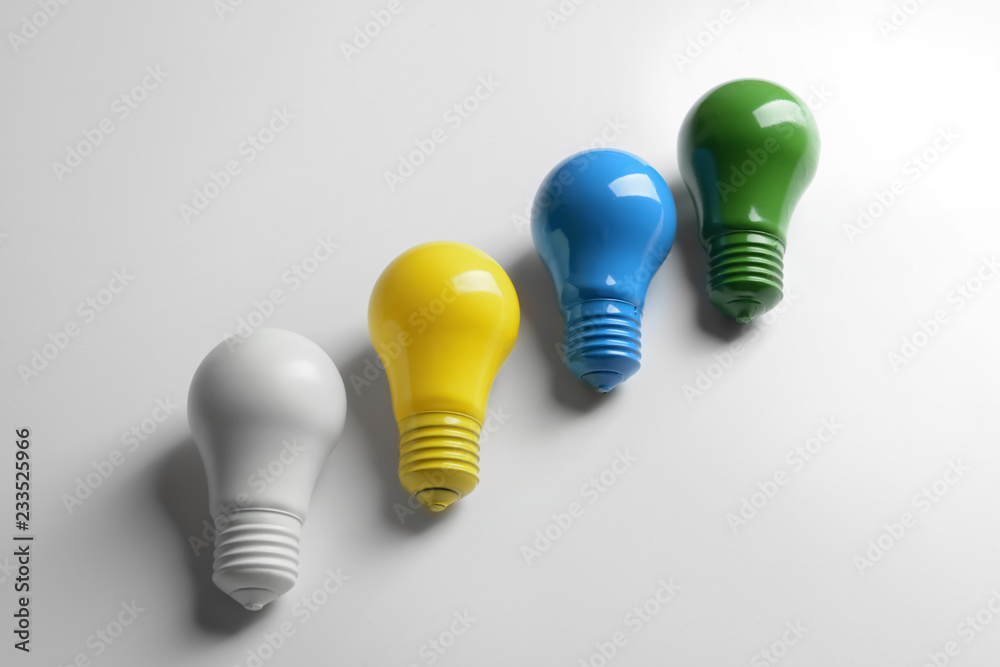 Painted light bulbs on white background