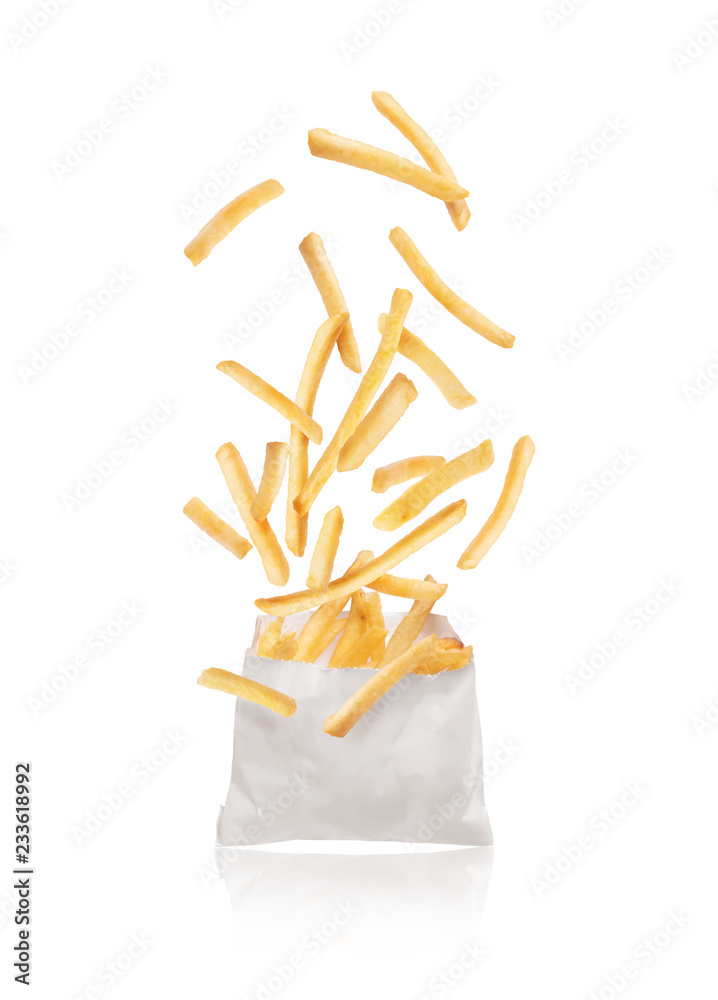 French fries flying out of paper packaging isolated on white background