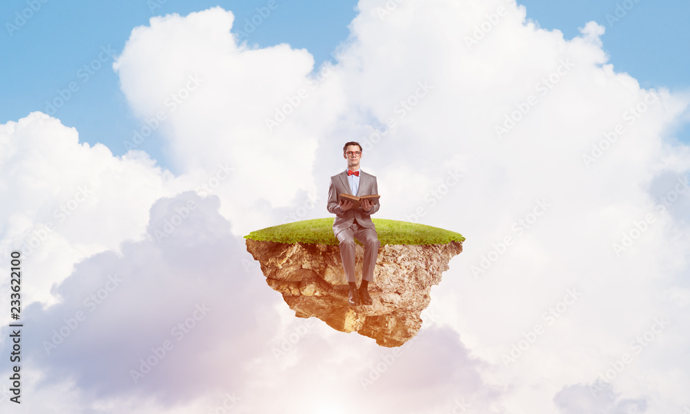 Young businessman or student floating in sky and studying the science