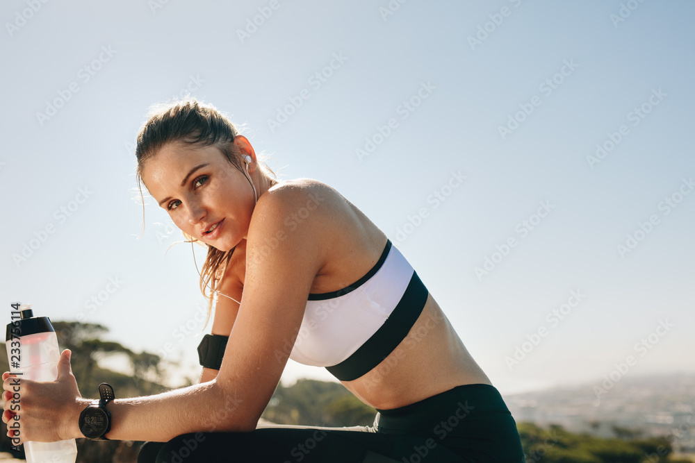 Close up of a female athlete taking a break from workout