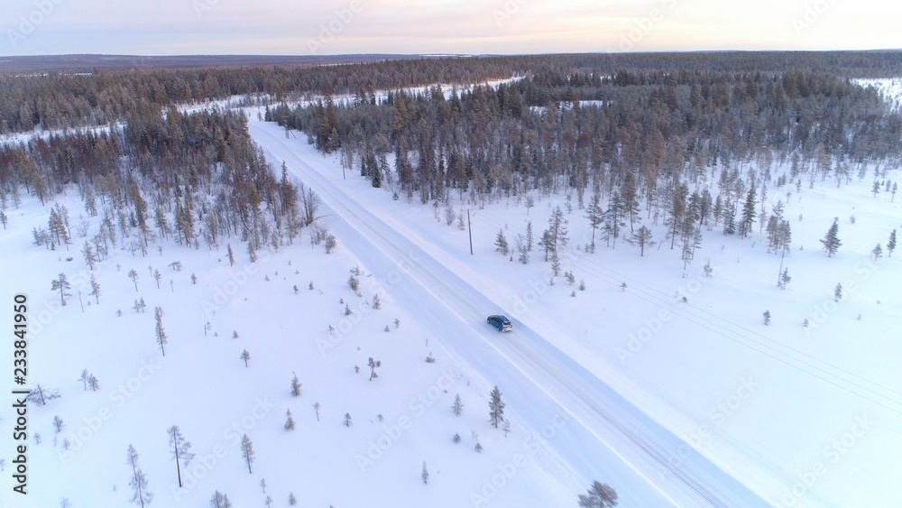 空中交通：汽车在拉普兰森林荒野的湿滑雪地上行驶