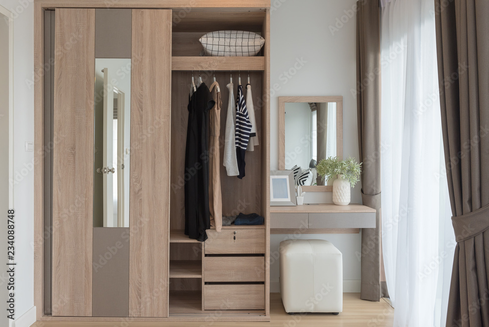 modern closet with clothes hanging on rail