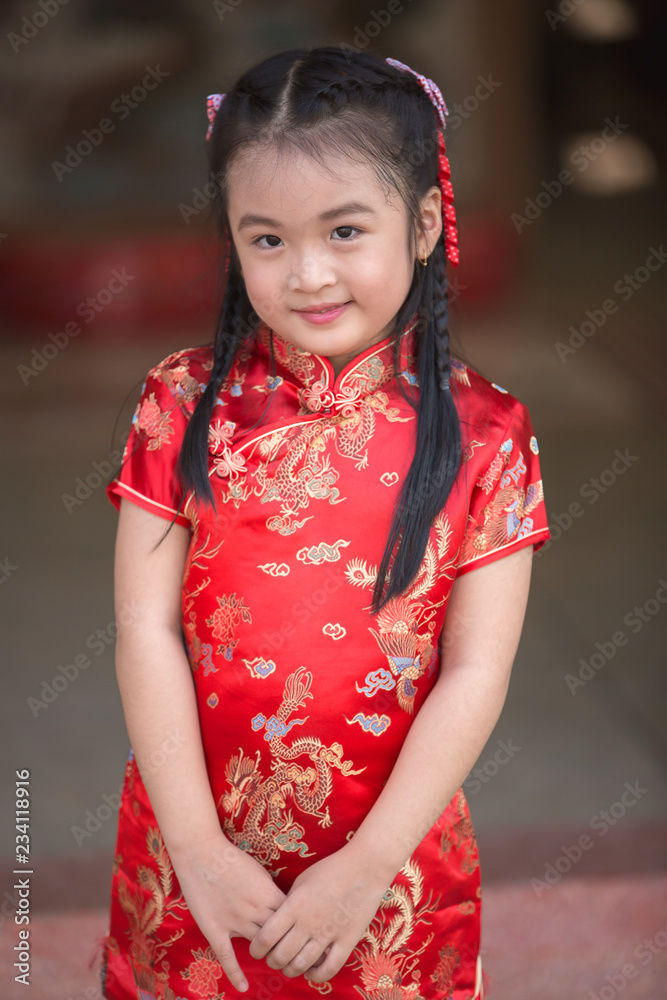 Little asian girl wishing you a happy Chinese New Year