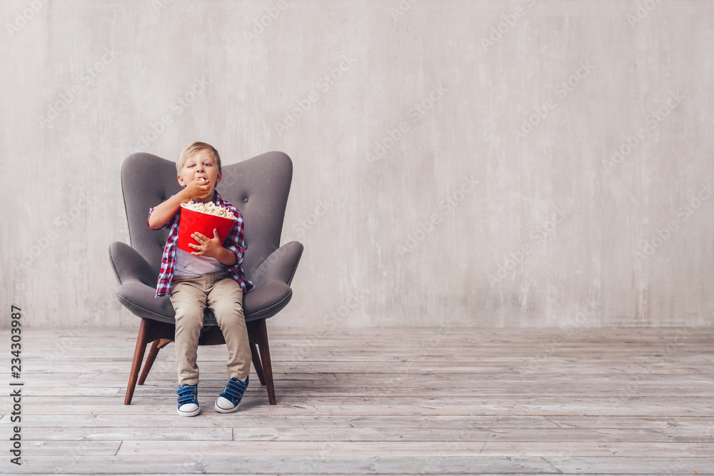 Little boy eating popcorn