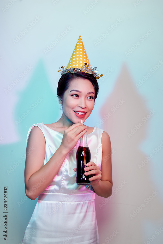 Portrait of beautiful happy cute asian woman in casual dress isolated on white, drinking cola from b