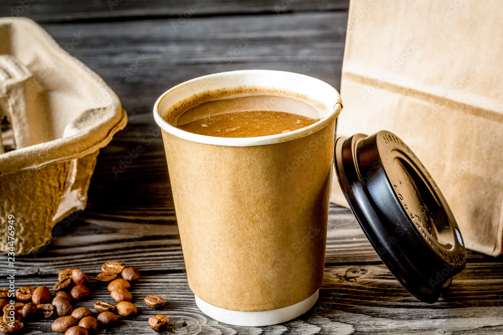 coffee cup to go at wooden background