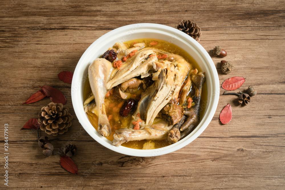 chicken soup with wooden background