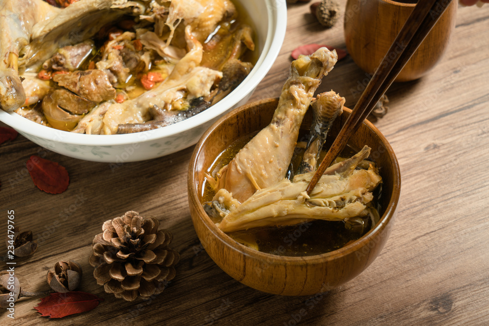 chicken soup with wooden background