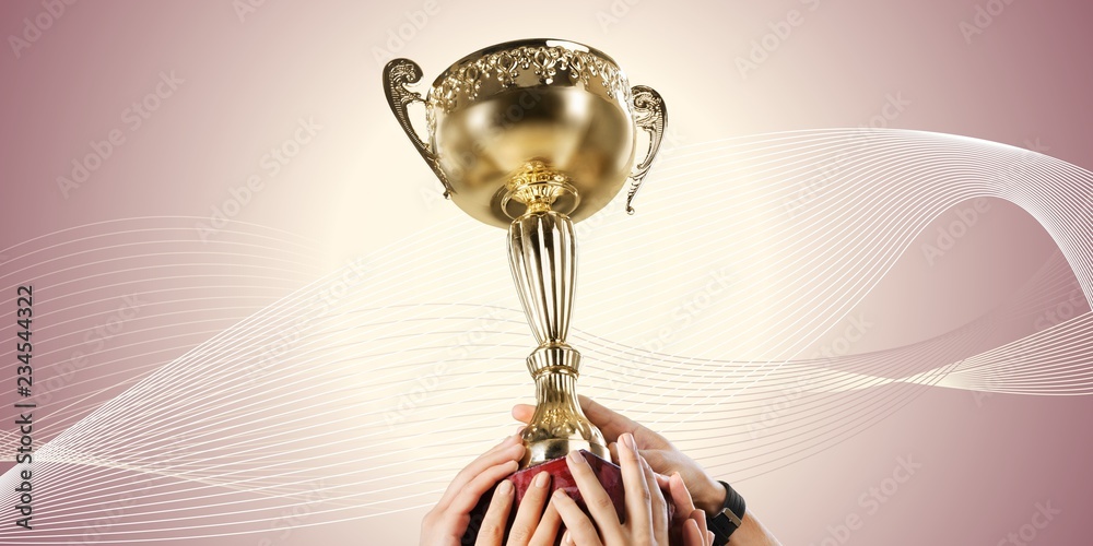 Hands holding a champion golden trophy on white background