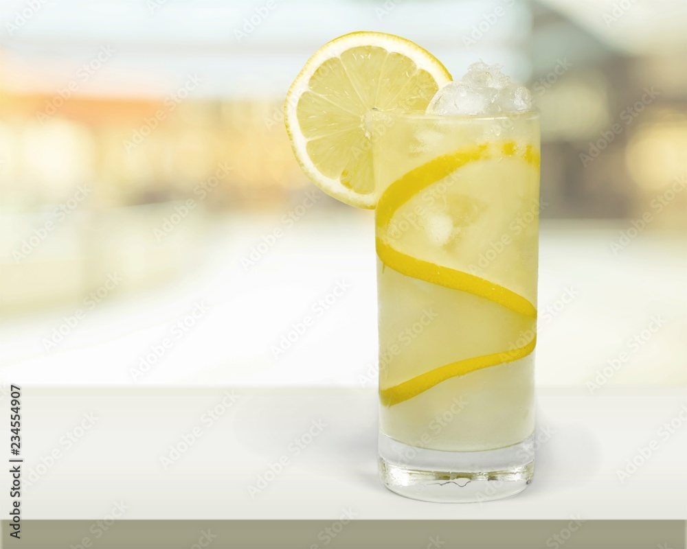 Lemonade with fresh lemon on  background