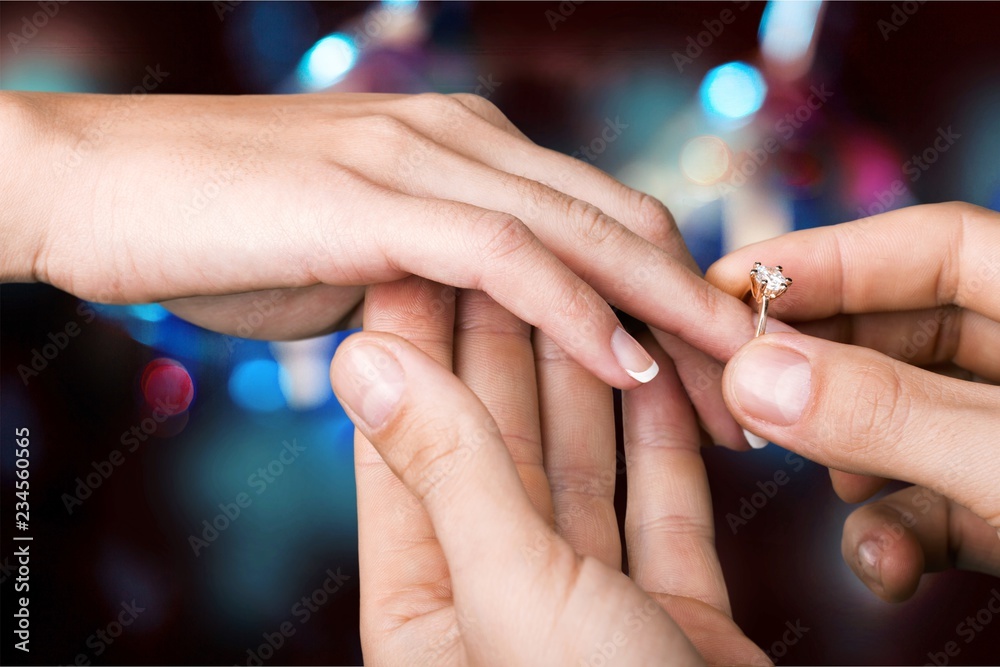 Close up Groom Putting the Wedding Ring on bride