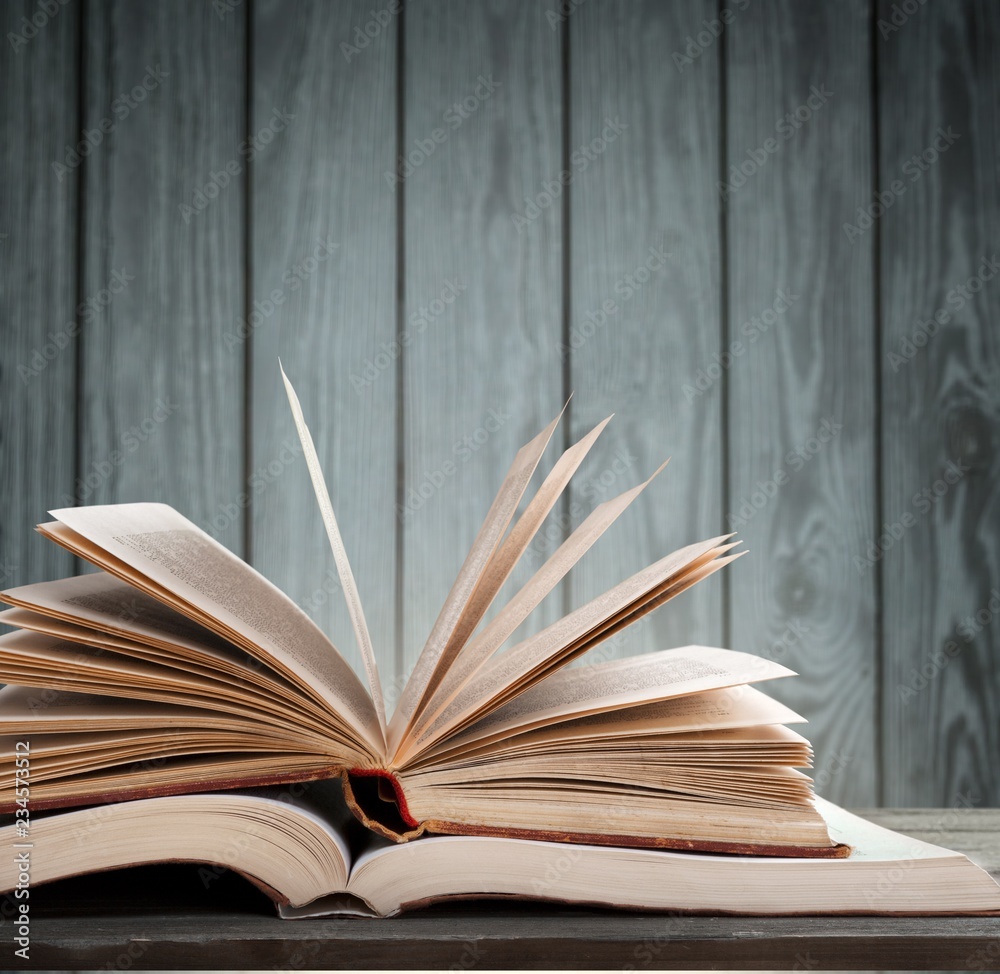 Big opened book with sparkles on background