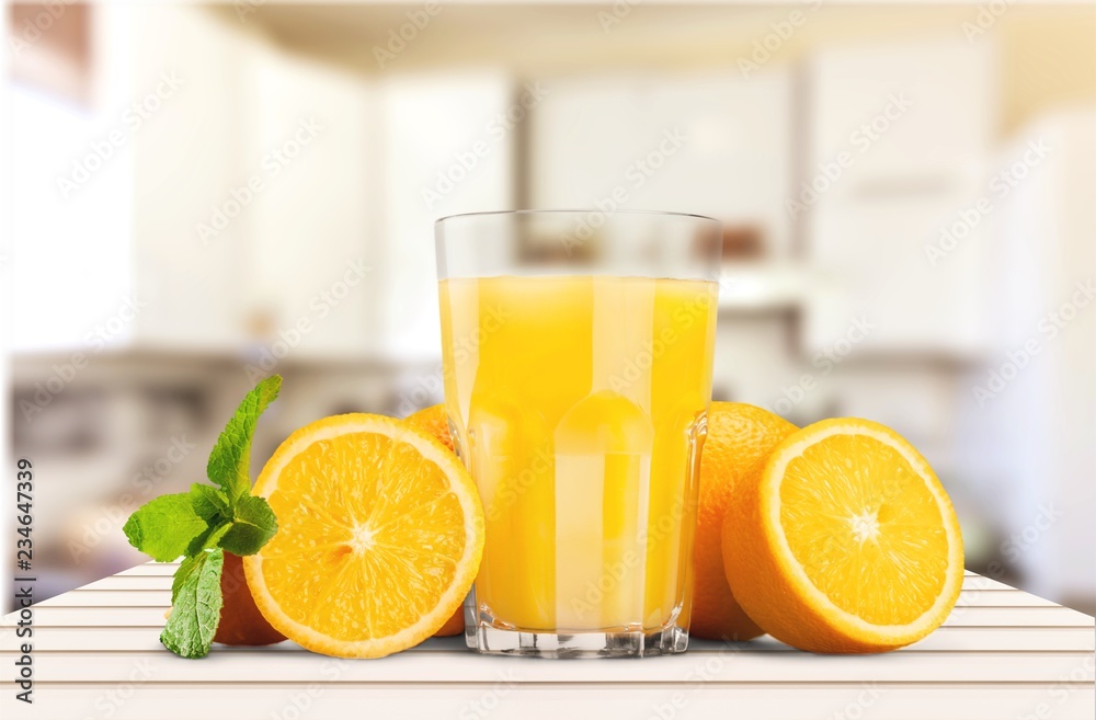 Orange juice and slices of orange on background