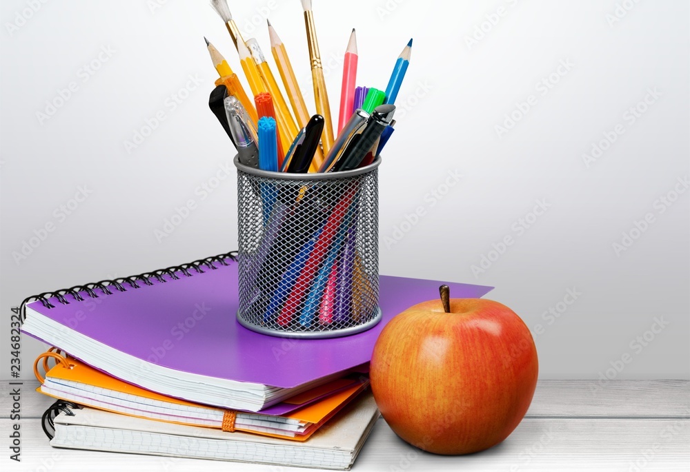 Colorful school supplies on blackboard background