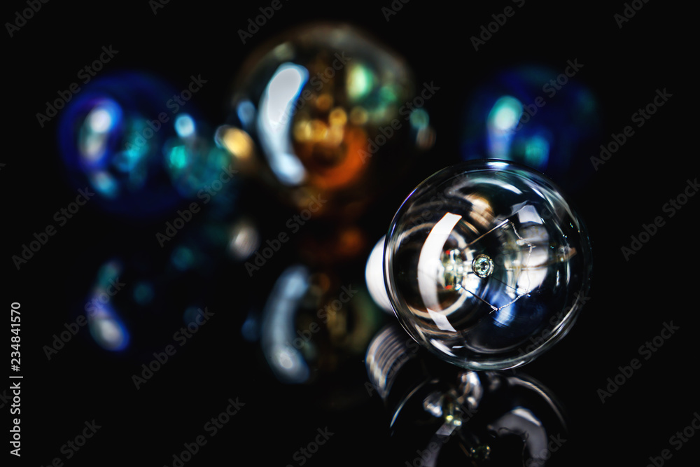 Retro light bulb with reflection on black table