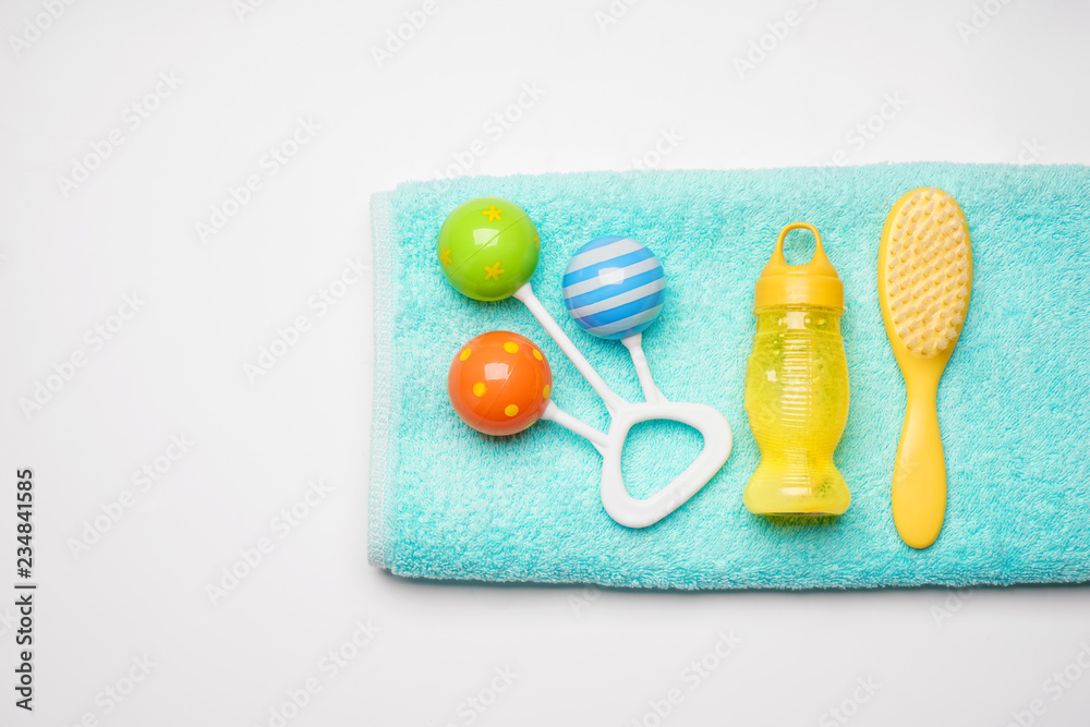 Towel and baby care accessories on white background