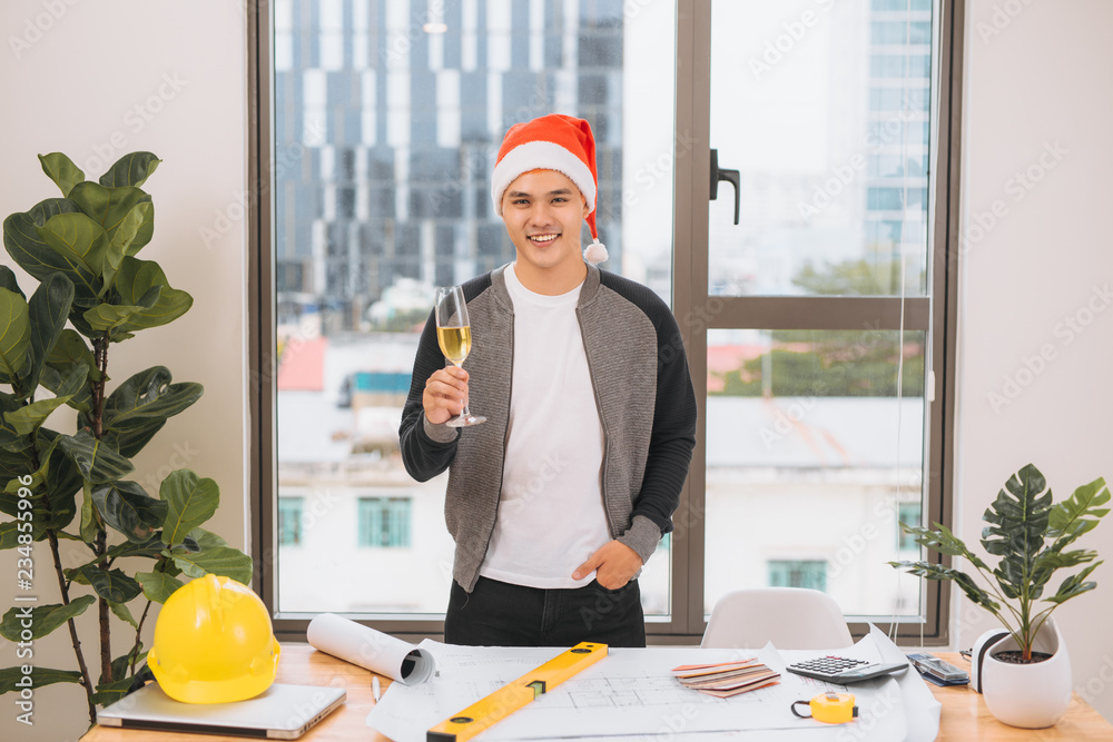 Happy architect celebrating Happy new year with wineglasses