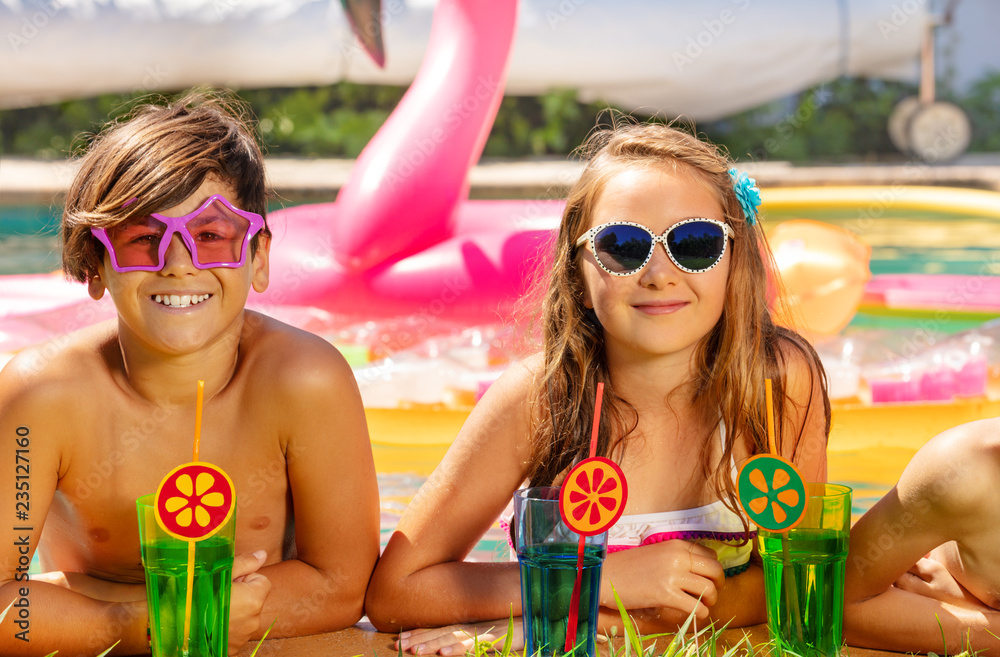 Happy boy and girl having fun during pool party