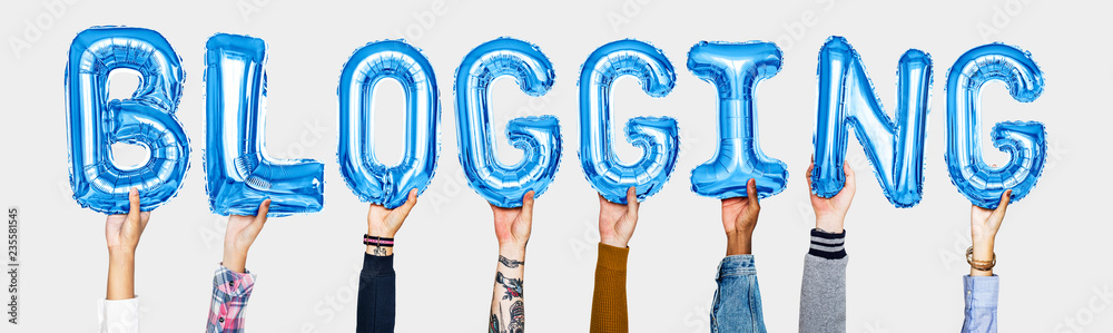 Hands holding blogging word in balloon letters