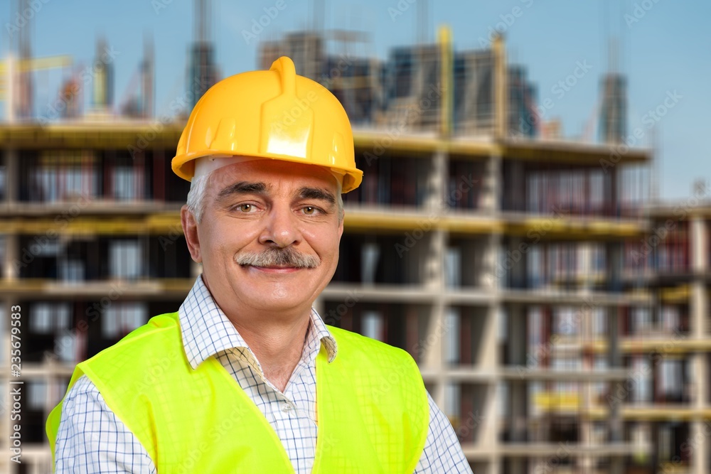 Male worker in hardhat smiling at camera