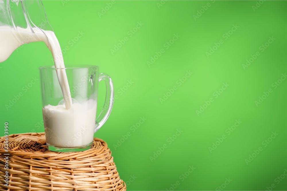 Glass of milk and bottle on  background