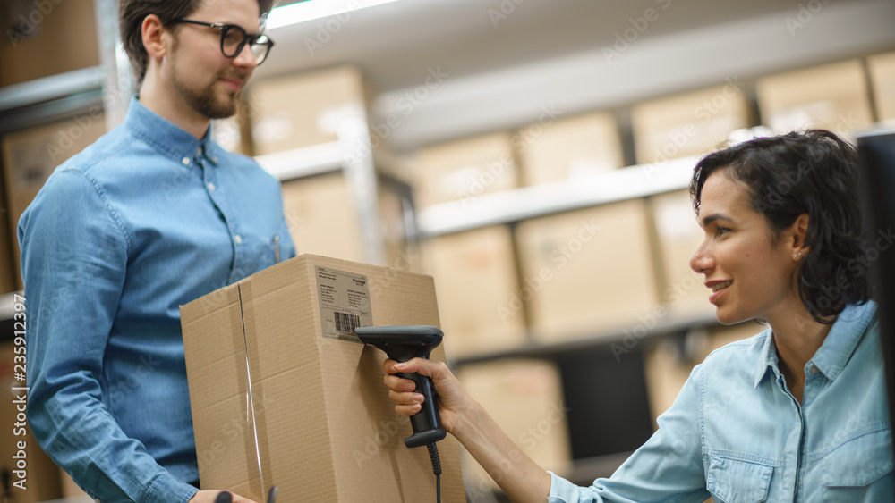 Female Inventory Manager Scans Cardboard Box and Digital Tablet with Barcode Scanner, Male Worker Ho