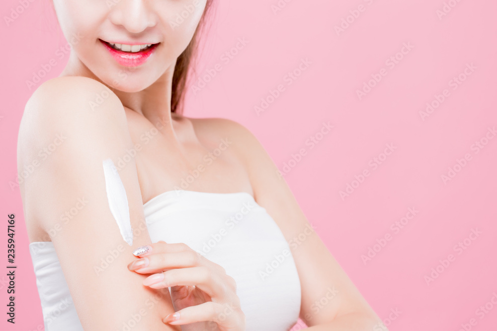 woman apply cream on arm