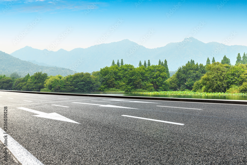 Empty asphalt road and green mountains