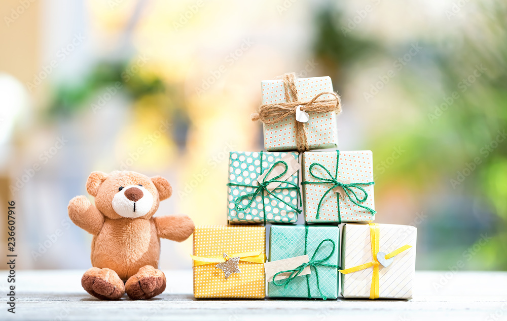 Christmas presents and teddy bear on a bright interior room background