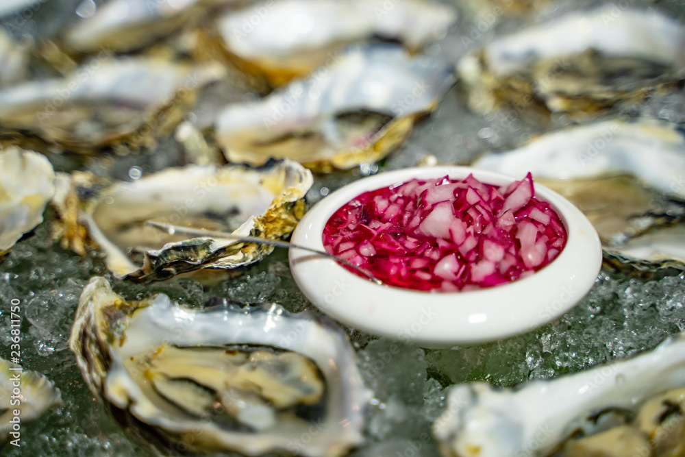 Freshs oyster served table with oysters, onion and ice. Healthy sea food of fresh oysters in ice and