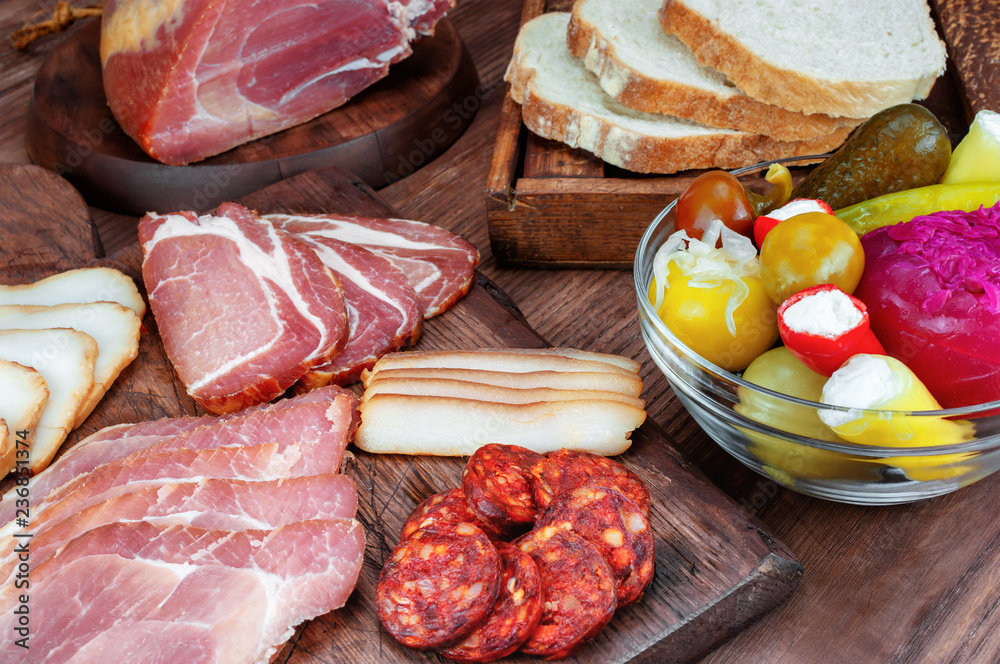 Smoked ham and bacon on wooden table