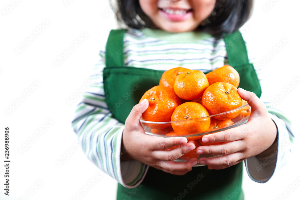 Asian kid with fresh orange. child girl with healthy fruit.