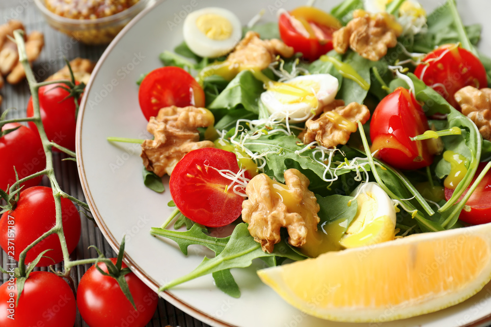 Delicious fresh salad with walnuts on plate