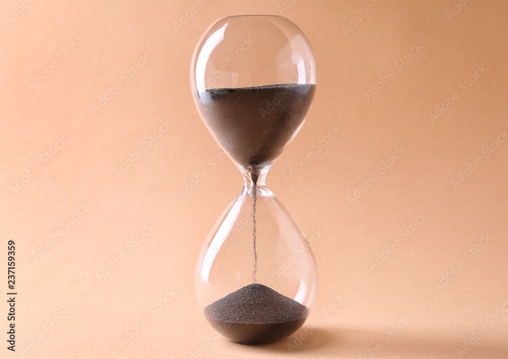 Hourglass on color background. Time management concept