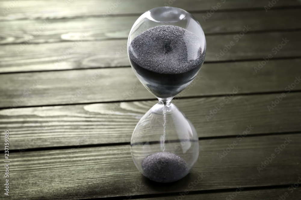 Hourglass on wooden background. Time management concept