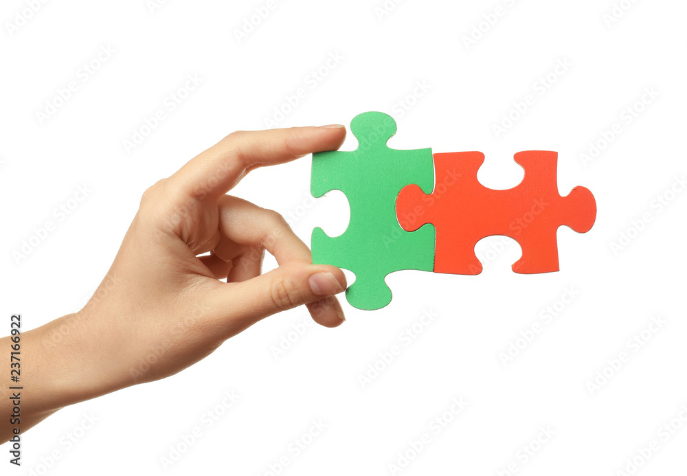 Woman with pieces of color puzzle on white background