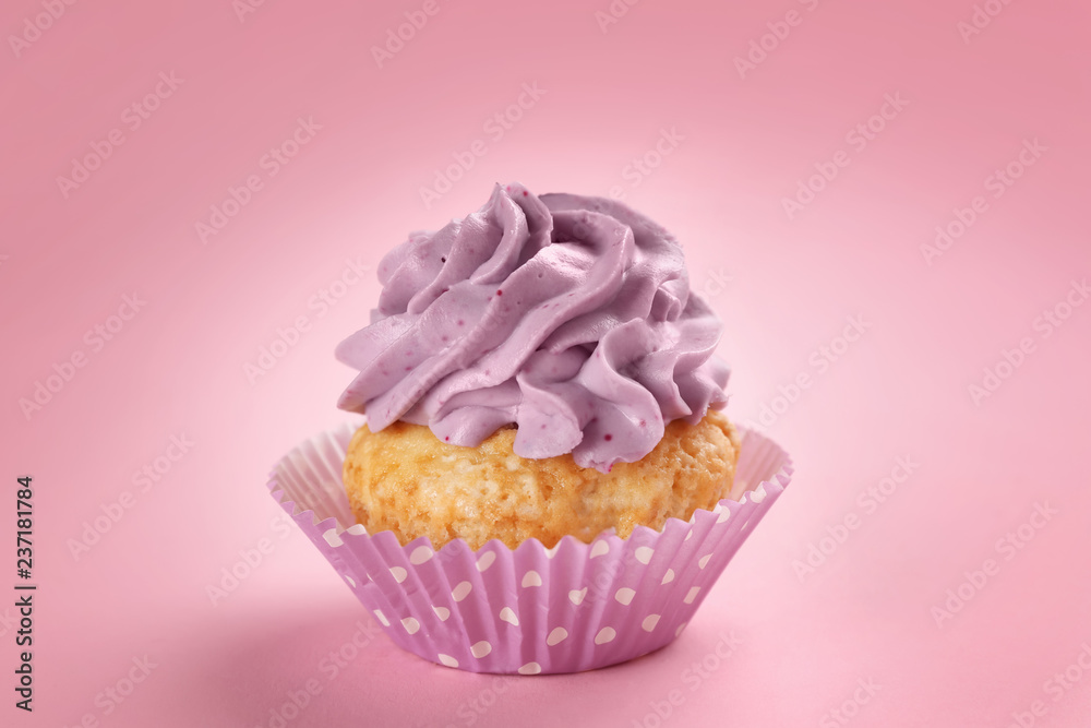 Tasty cupcake on color background