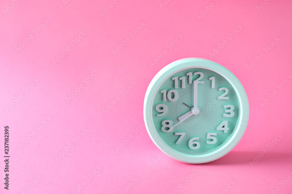 Alarm clock on color background