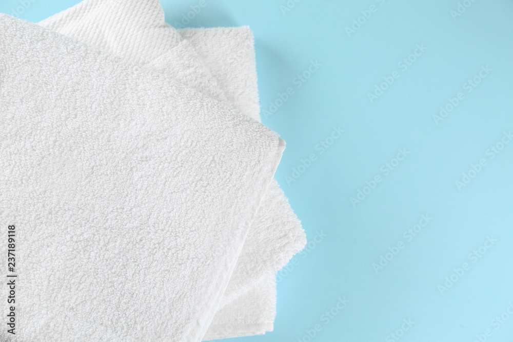 Soft towels on color background