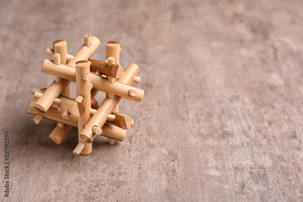 Wooden puzzle on textured background