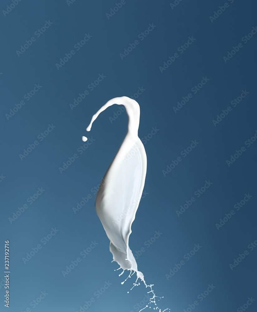 Splash of milk on color background