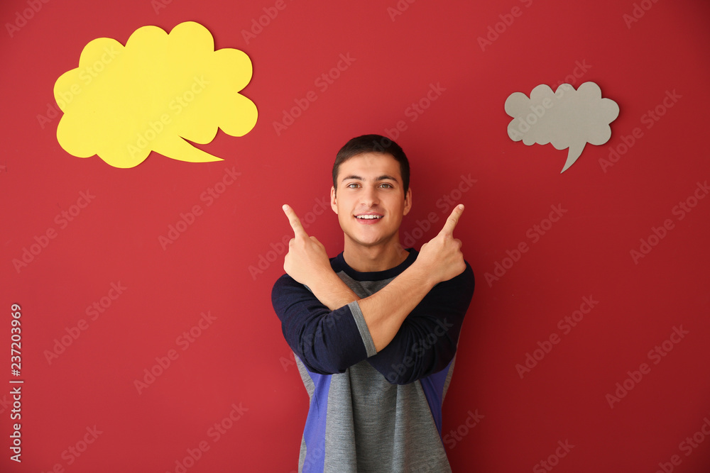 Young man with speech bubbles on color background