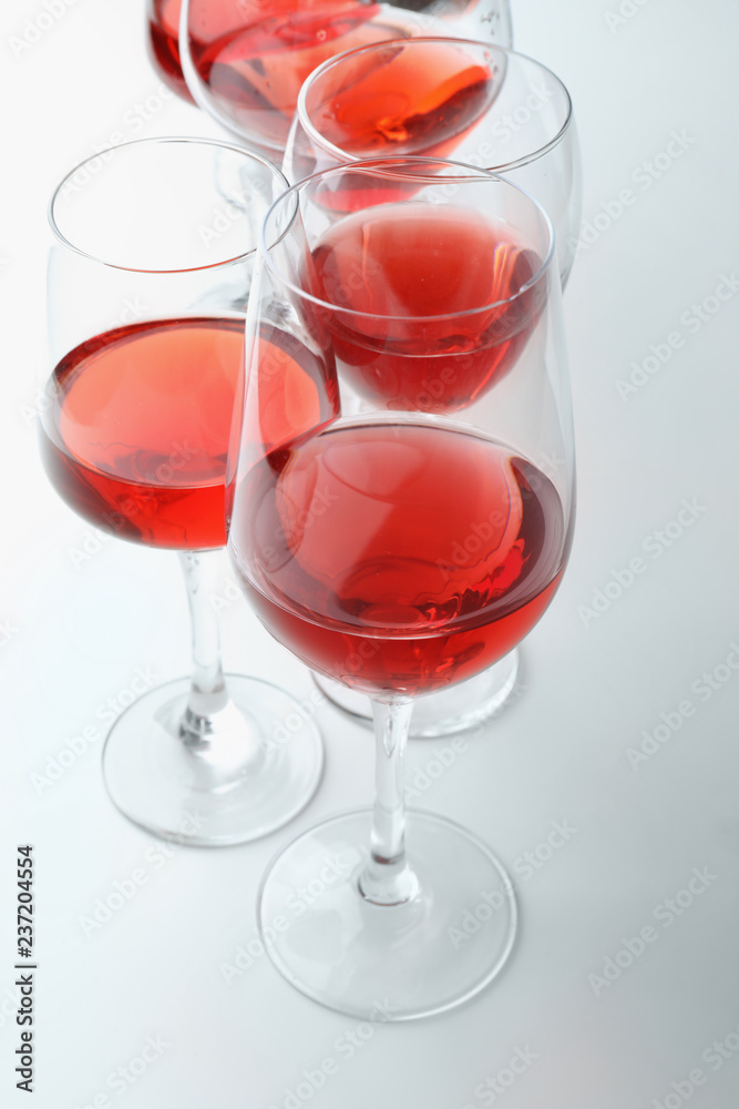 Glasses of sweet wine on white background