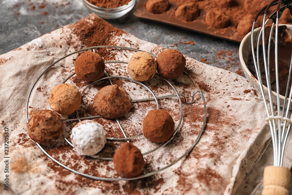 Tasty chocolate truffles on metal stand