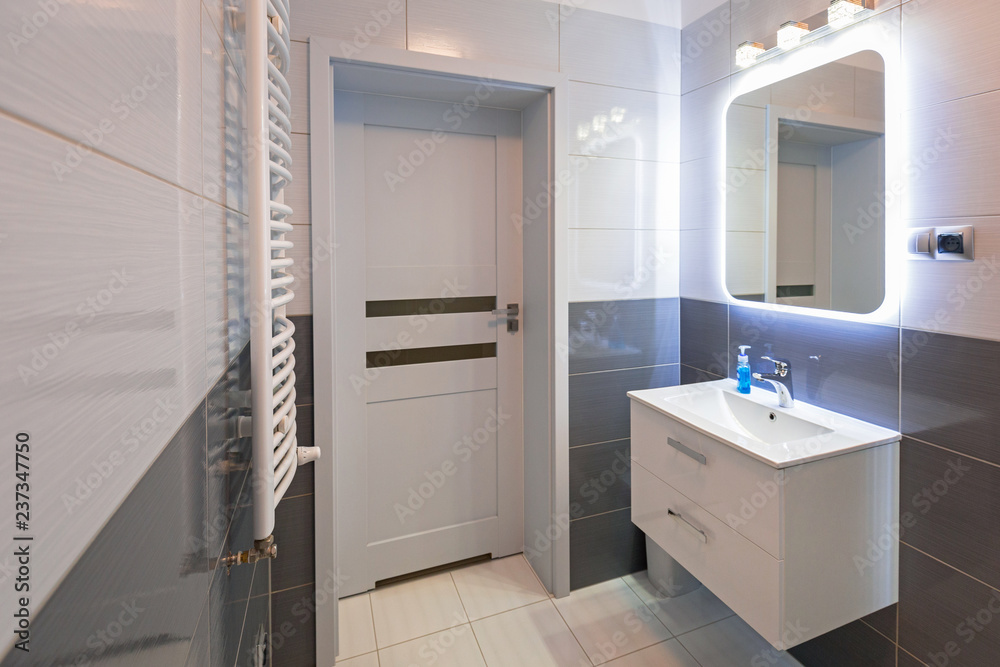 New bathroom interior with illuminated mirror