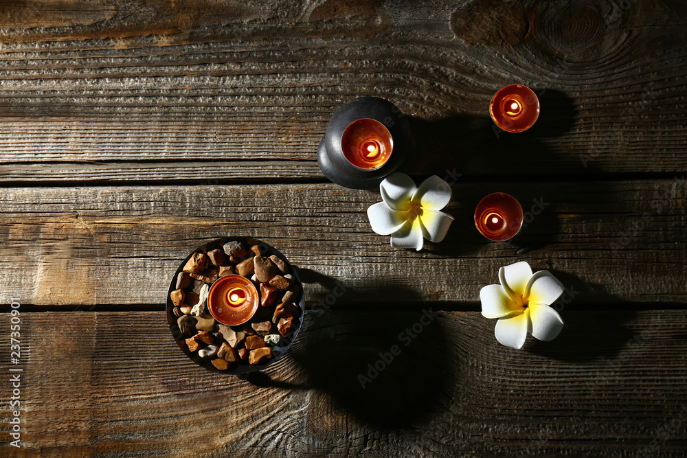 Beautiful spa composition with burning candles on wooden background