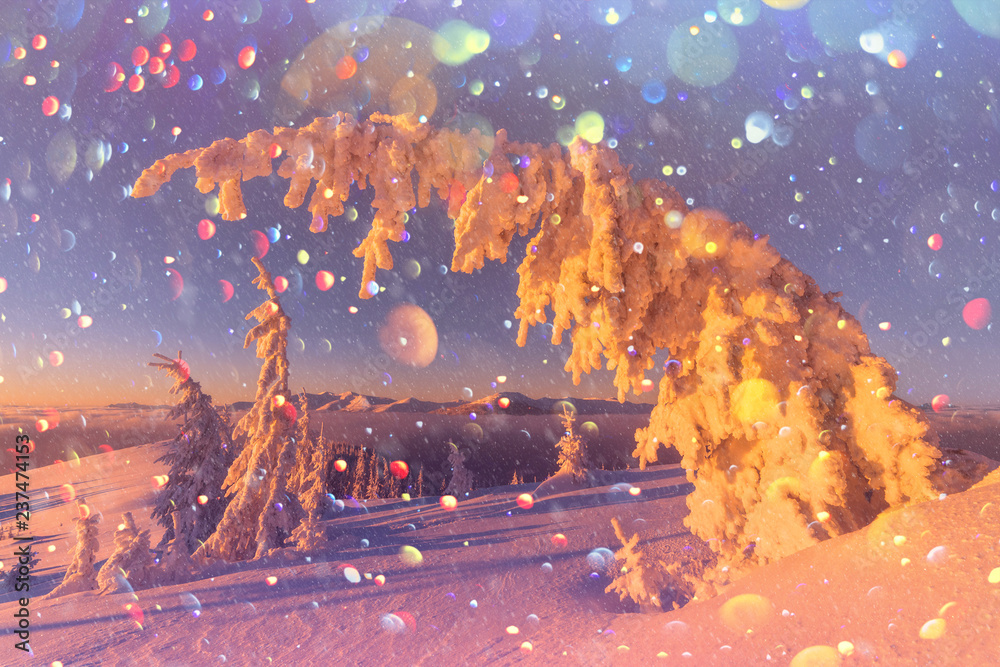 Fantastic orange winter landscape in snowy mountains glowing by sunlight. Dramatic wintry scene with